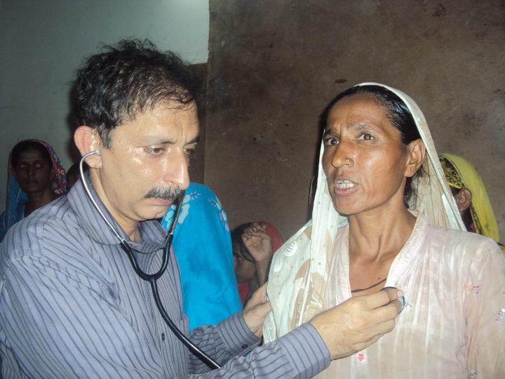 Dr. Agha Taj examining a patient
